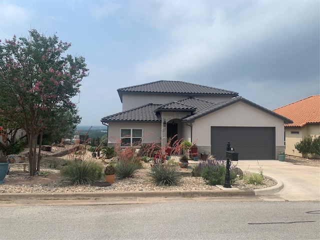 103 Valley Vw, Glen Rose, TX 76043 - mediterranean / spanish house featuring stucco siding, a garage, driveway, and a tiled roof