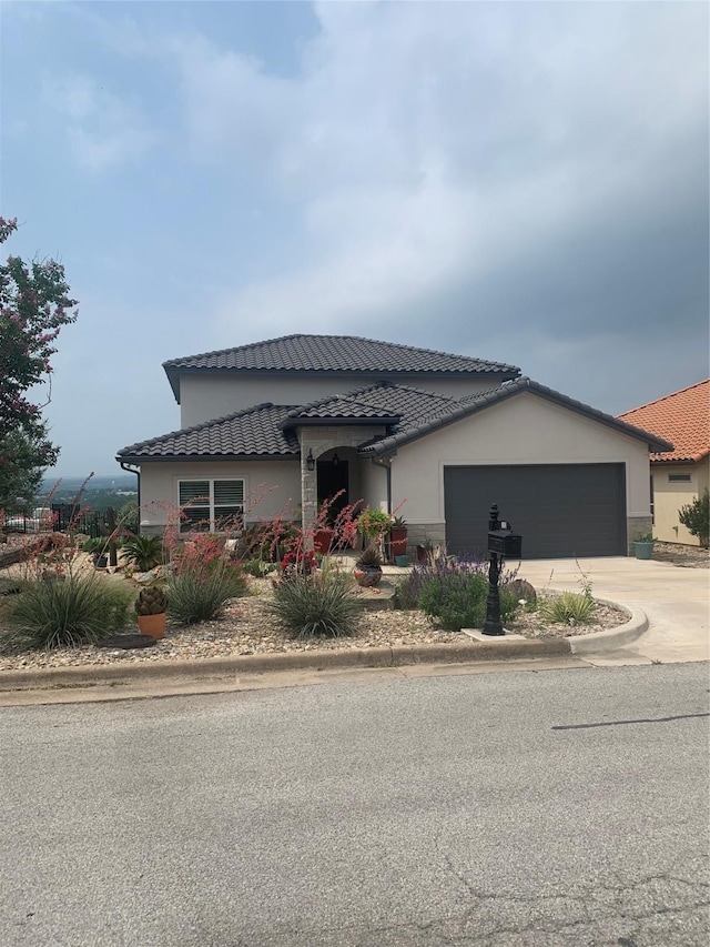 103 Valley Vw, Glen Rose, TX 76043 - view of property exterior with a tiled roof, concrete driveway, an attached garage, and stucco siding