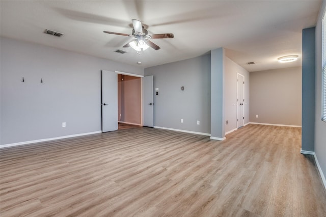unfurnished room featuring a ceiling fan, baseboards, light wood-style flooring, and visible vents
