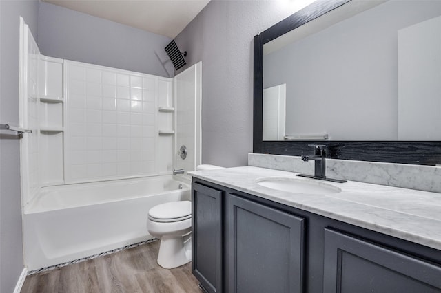bathroom with  shower combination, wood finished floors, toilet, and vanity