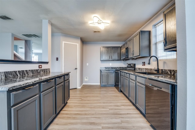 kitchen featuring range with electric stovetop, a sink, visible vents, dishwasher, and black microwave