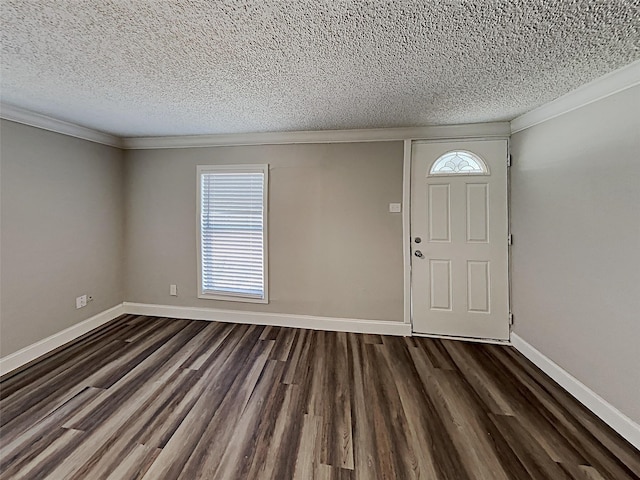entryway with dark wood finished floors, plenty of natural light, crown molding, and baseboards
