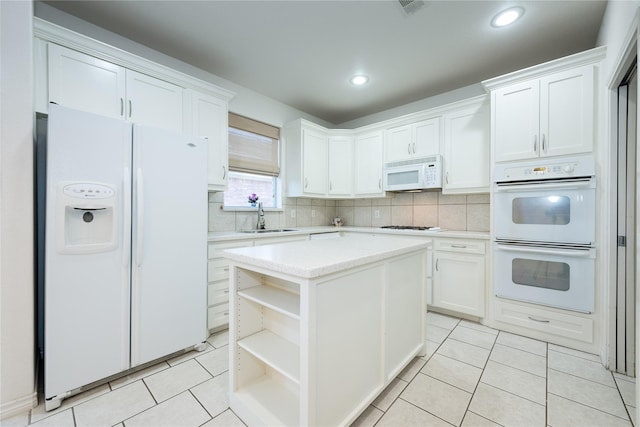 1505 Valley Creek Rd, Denton, TX 76205 - kitchen with white appliances, a sink, open shelves, white cabinetry, and light tile patterned flooring