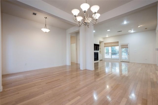 1505 Valley Creek Rd, Denton, TX 76205 - unfurnished living room featuring light wood-type flooring, baseboards, a chandelier, recessed lighting, and a glass covered fireplace