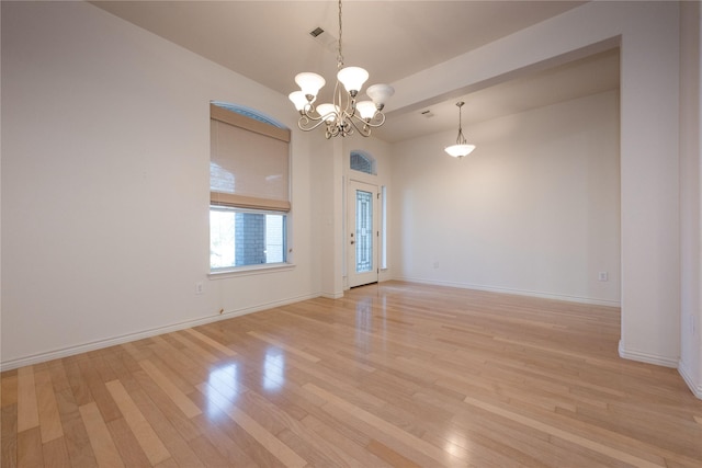 1505 Valley Creek Rd, Denton, TX 76205 - empty room with a chandelier, light wood-style floors, and baseboards