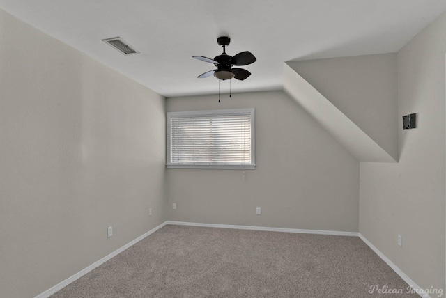 additional living space featuring visible vents, carpet flooring, baseboards, and a ceiling fan