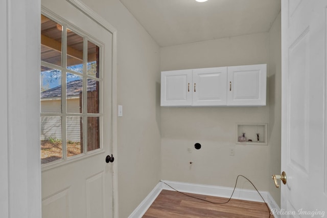 washroom with washer hookup, wood finished floors, cabinet space, and baseboards