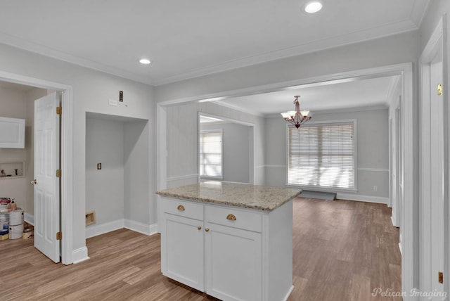 kitchen featuring white cabinetry, light wood-type flooring, and ornamental molding