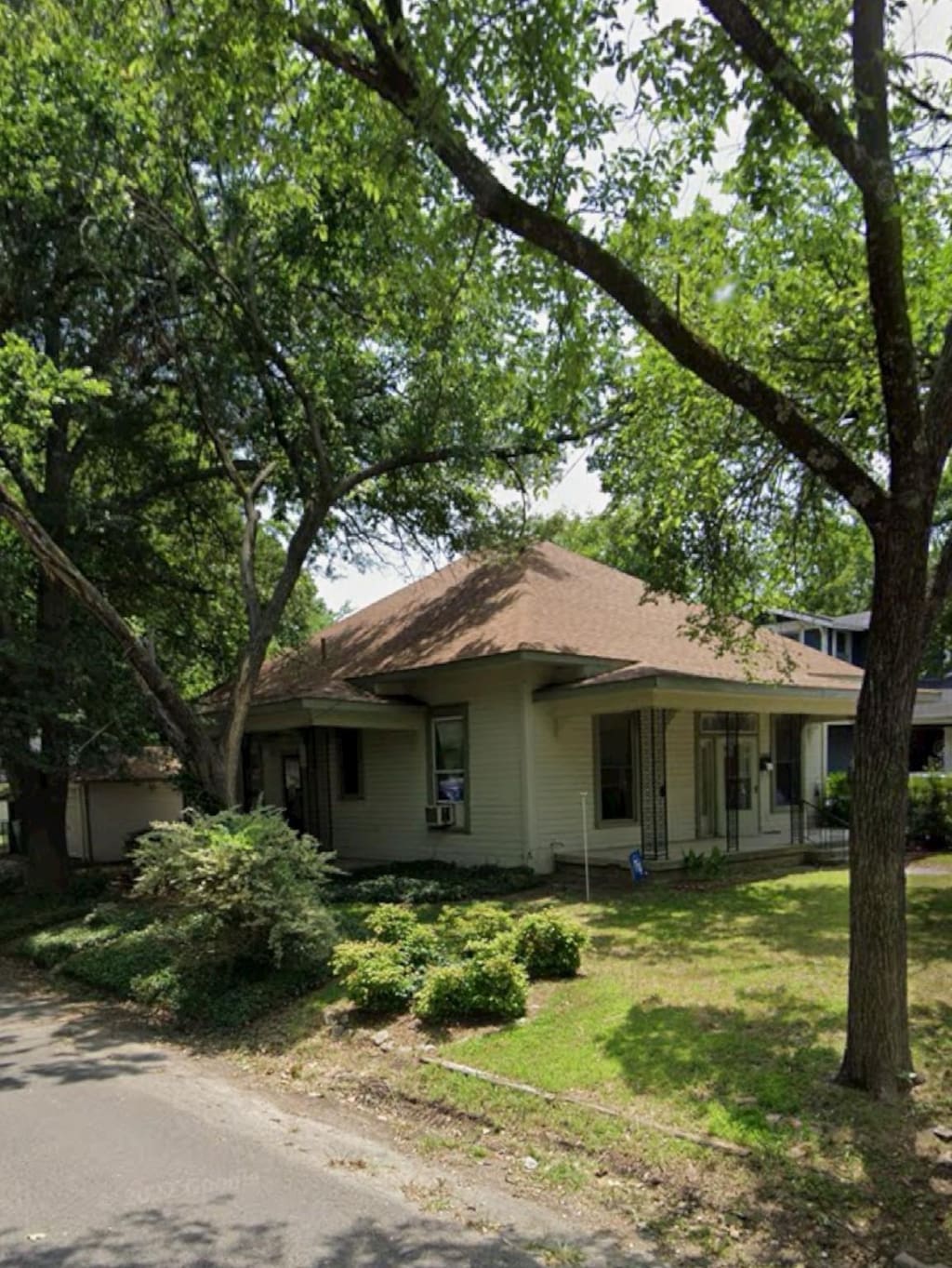 ranch-style home with covered porch and a front yard