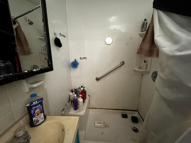 bathroom with decorative backsplash and vanity