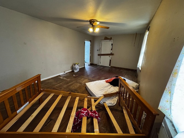 unfurnished bedroom with a ceiling fan and baseboards