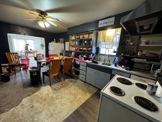 kitchen featuring a sink, wood finished floors, white appliances, extractor fan, and ceiling fan