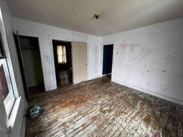 unfurnished bedroom featuring a closet and wood finished floors