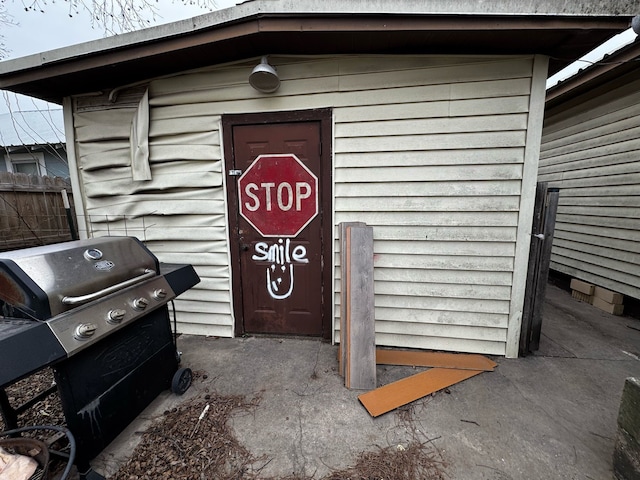 view of exterior entry featuring fence