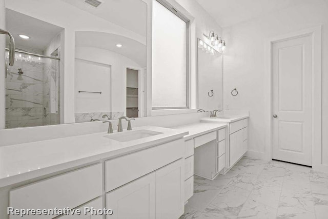 bathroom featuring recessed lighting, a marble finish shower, marble finish floor, and vanity