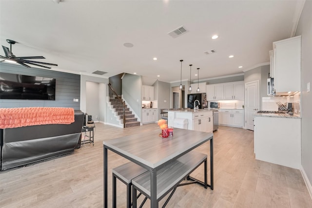 9032 Weepy Hollow Trl, Fort Worth, TX 76179 - dining room featuring visible vents, light wood-style flooring, stairs, and a ceiling fan