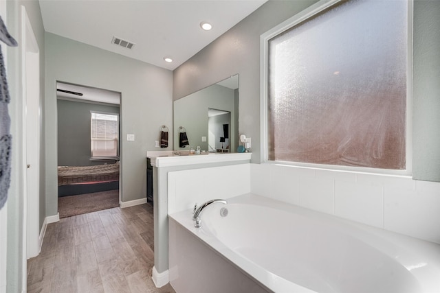 9032 Weepy Hollow Trl, Fort Worth, TX 76179 - ensuite bathroom with vanity, baseboards, visible vents, a bath, and connected bathroom