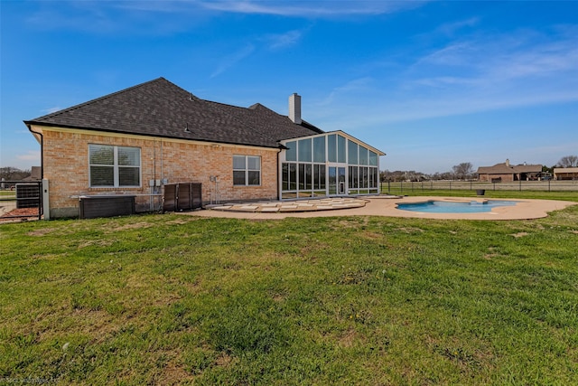 477 Horseshoe Bnd, Royse City, TX 75189 - back of house with a sunroom, a patio, roof with shingles, brick siding, and a chimney