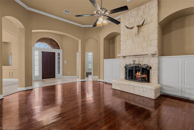 477 Horseshoe Bnd, Royse City, TX 75189 - unfurnished living room with hardwood / wood-style floors, a ceiling fan, a stone fireplace, and ornamental molding