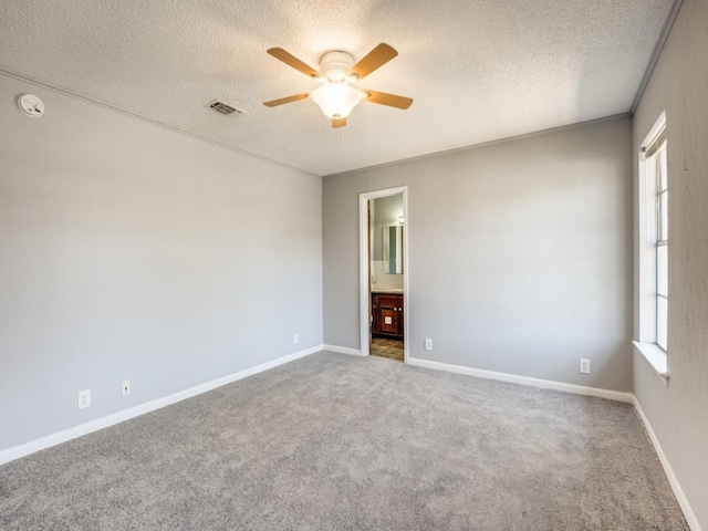 1805 Jamaica Ln, Sherman, TX 75092 - unfurnished room featuring plenty of natural light, a ceiling fan, a textured ceiling, and visible vents