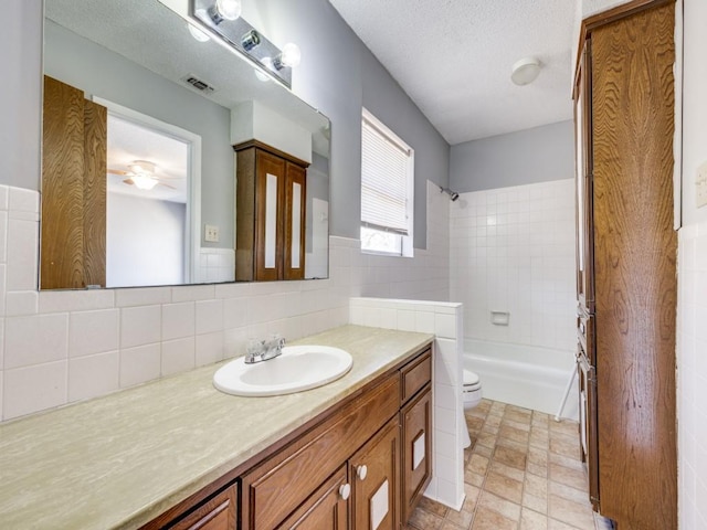 1805 Jamaica Ln, Sherman, TX 75092 - bathroom with vanity, visible vents, shower / bathtub combination, toilet, and a ceiling fan