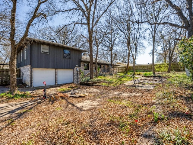 1805 Jamaica Ln, Sherman, TX 75092 - view of side of property with an attached garage, fence, driveway, and cooling unit