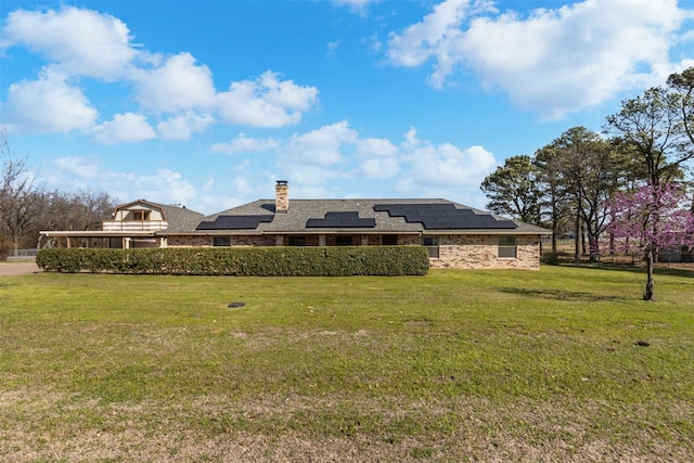 101 Hill Top Cir, Burleson, TX 76028 - rear view of property featuring a chimney, solar panels, stone siding, and a yard