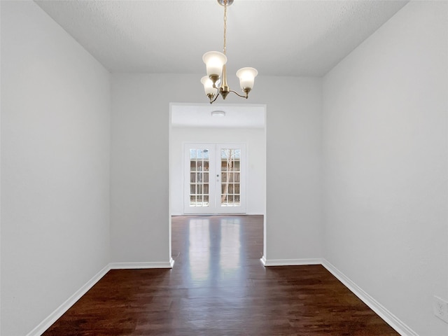 925 Old Mill Cir, Irving, TX 75061 - unfurnished dining area featuring baseboards, an inviting chandelier, french doors, and dark wood-type flooring