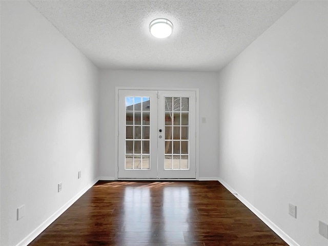 925 Old Mill Cir, Irving, TX 75061 - empty room featuring a textured ceiling, wood finished floors, french doors, and baseboards