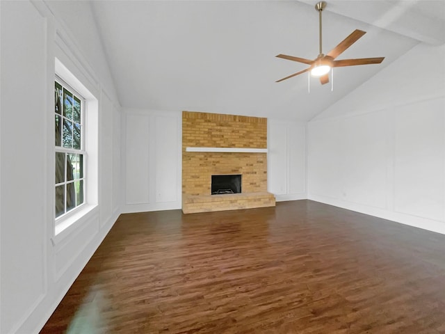 925 Old Mill Cir, Irving, TX 75061 - unfurnished living room with beamed ceiling, a fireplace, ceiling fan, a decorative wall, and dark wood finished floors