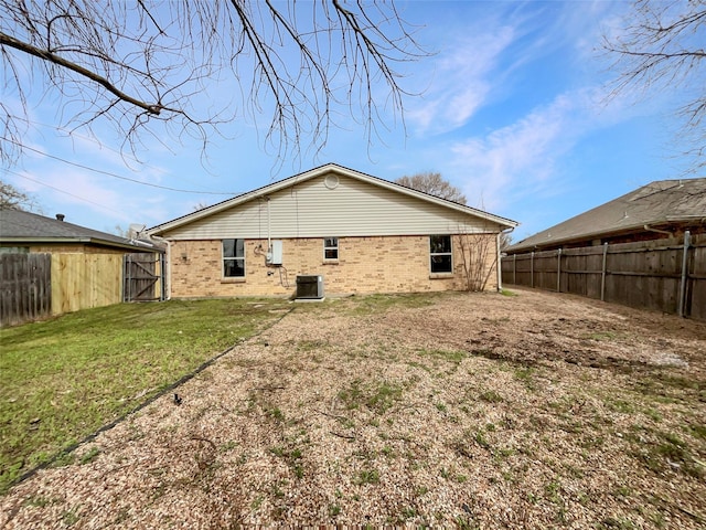 925 Old Mill Cir, Irving, TX 75061 - rear view of house with cooling unit, a gate, a fenced backyard, and brick siding