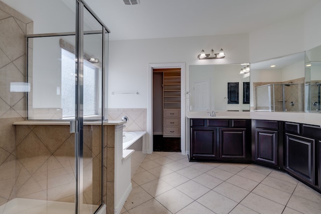 bathroom with vanity, a stall shower, tile patterned floors, visible vents, and a garden tub