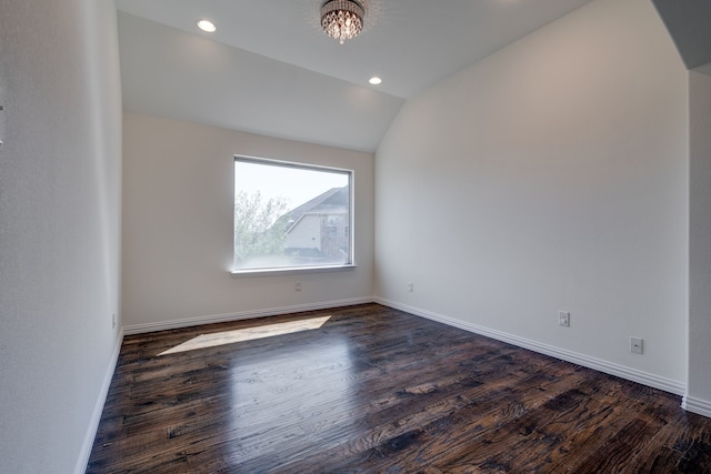 empty room featuring baseboards, a notable chandelier, dark wood-style floors, recessed lighting, and vaulted ceiling