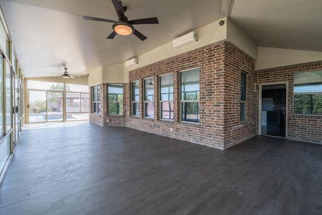 unfurnished sunroom featuring a wall mounted air conditioner and a wealth of natural light