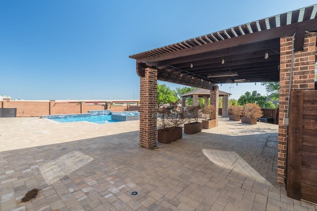 view of patio / terrace featuring a gazebo and a pool with connected hot tub
