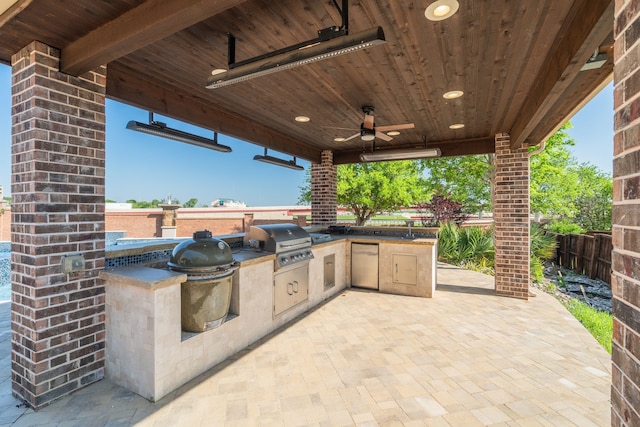 view of patio featuring area for grilling, ceiling fan, and fence