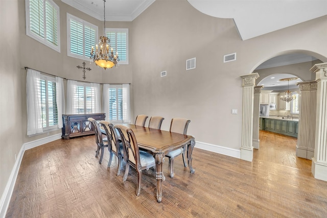 2909 Canyon Creek Dr, Sherman, TX 75092 - dining space with a chandelier, ornate columns, arched walkways, ornamental molding, and plenty of natural light