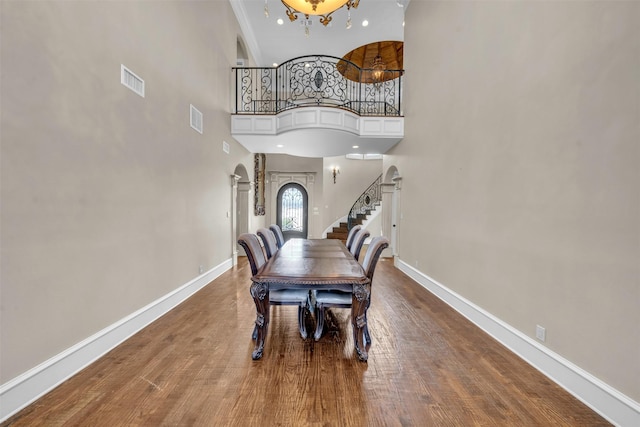 2909 Canyon Creek Dr, Sherman, TX 75092 - dining room featuring a towering ceiling, arched walkways, and wood finished floors
