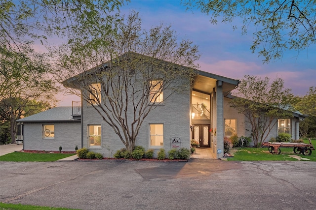 view of front of house featuring brick siding and french doors
