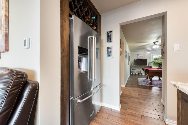 kitchen with pool table, a ceiling fan, high end refrigerator, light wood finished floors, and baseboards