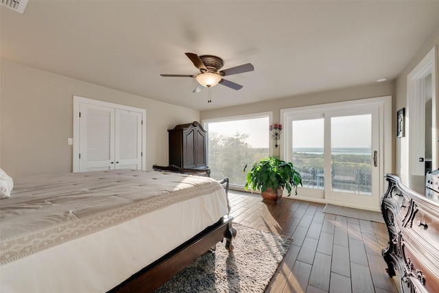 bedroom with visible vents, wood finish floors, and ceiling fan