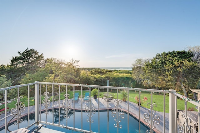 view of pool with a lawn