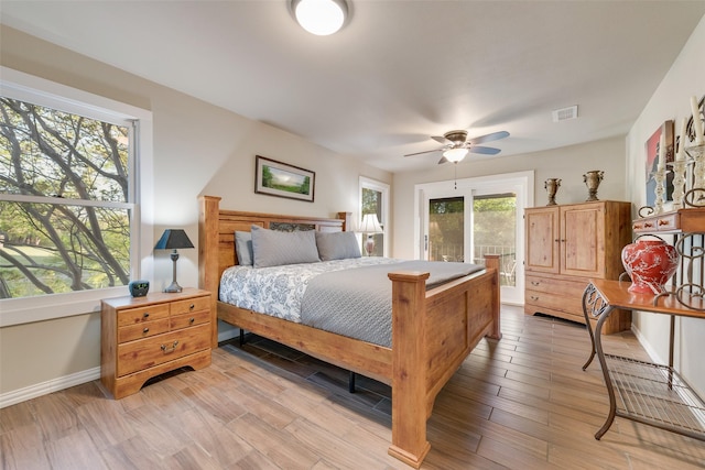 bedroom featuring visible vents, light wood-type flooring, baseboards, and a ceiling fan