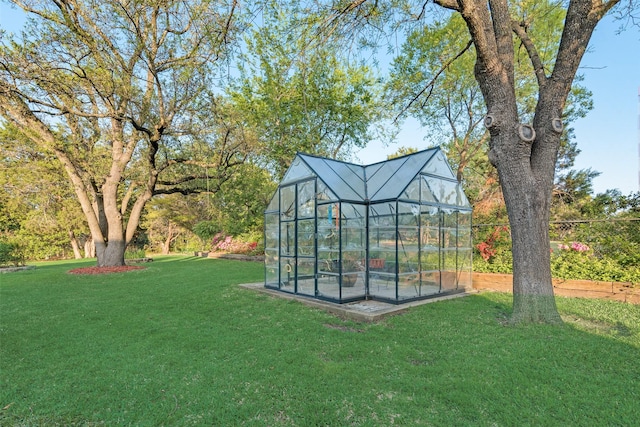 view of yard with an outdoor structure and a greenhouse
