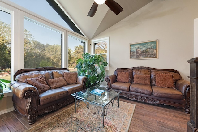 living room with a ceiling fan, plenty of natural light, wood finished floors, and lofted ceiling