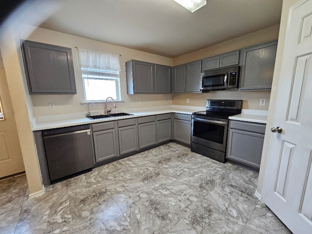 1416 Connie St, Burleson, TX 76028 - kitchen with a sink, light countertops, gray cabinets, and appliances with stainless steel finishes