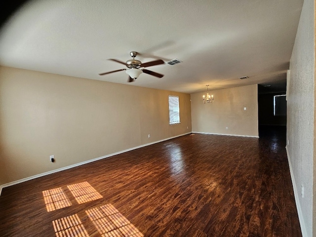 1416 Connie St, Burleson, TX 76028 - empty room featuring visible vents, baseboards, ceiling fan with notable chandelier, and dark wood-style floors
