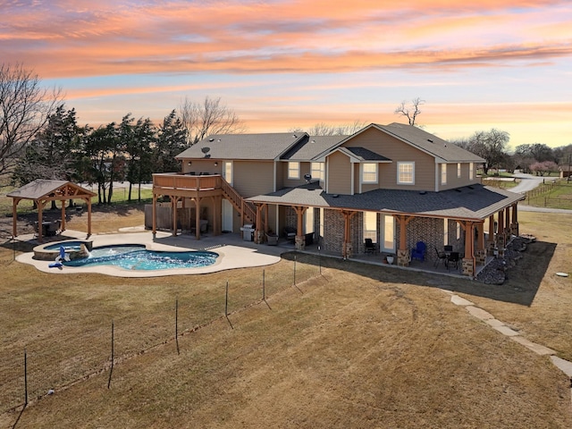 back of property featuring fence, a patio, a gazebo, a lawn, and a shingled roof
