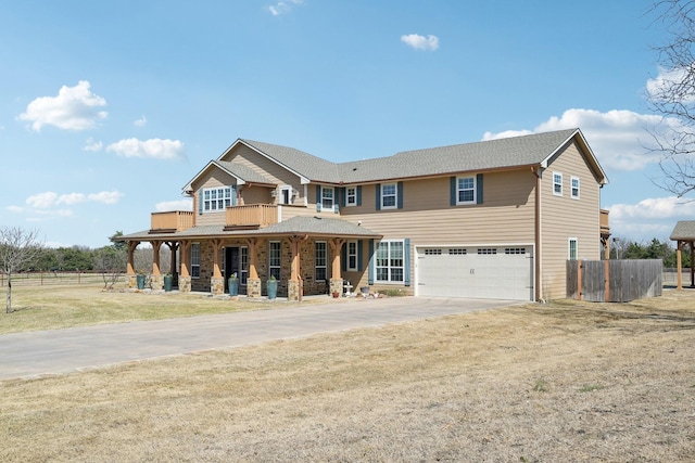 view of front facade featuring concrete driveway, fence, a garage, a front lawn, and a porch