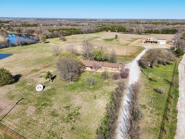 drone / aerial view featuring a water view and a rural view